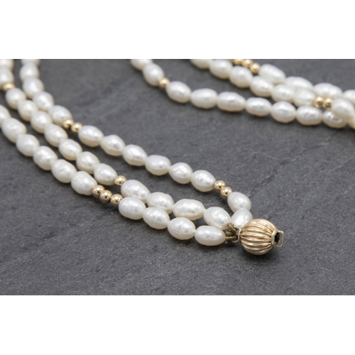 83 - Vintage 9ct and freshwater pearl three strand necklace, 43cm long