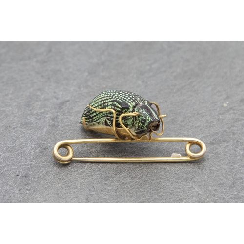 95 - 18ct petrified Scarab Beetle brooch, 4.5cm long, 4g