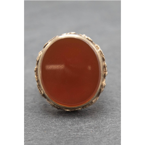 104 - 9ct large carnelian signet ring, size R/S, 12.9g