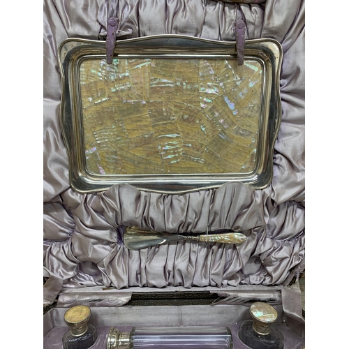 199 - The most remarkable silver and mother of pearl dressing or vanity set, the larger leather case fitte... 