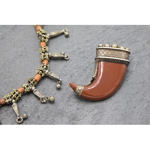 127 - Victorian silver gilt and coral fringe necklace, 38cm long with a carved coral claw brooch (2)