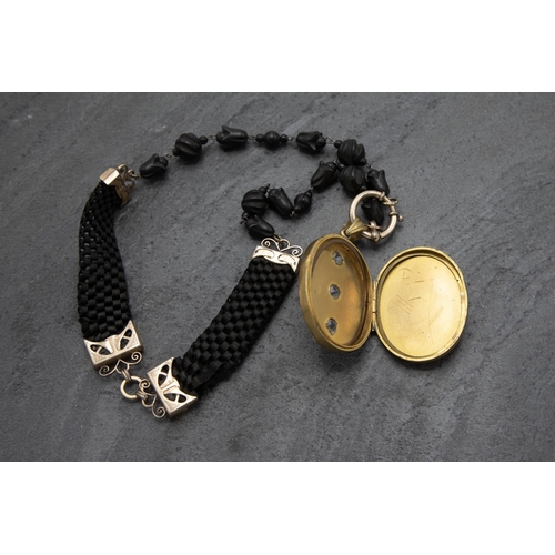 130 - Unusual mid 19th century silver gilt, Whitby jet and woven mourning necklace and pendant, the locket... 