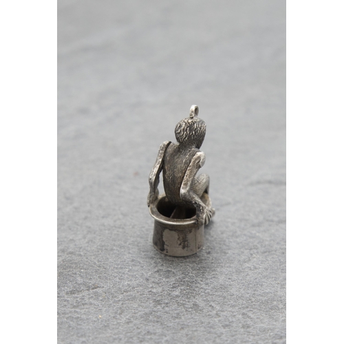 136 - Novelty silver cigar cutter charm in the form of a seated monkey, 3.5cm high