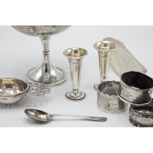 193 - Mixed silver comprising tazza, five napkin rings, two small vases, strainer, egg cup, 800 fish slice... 