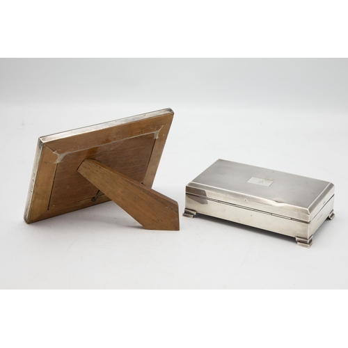 194 - Engine turned silver cigarette box, cedar lined interior, with a further silver easel frame (2)