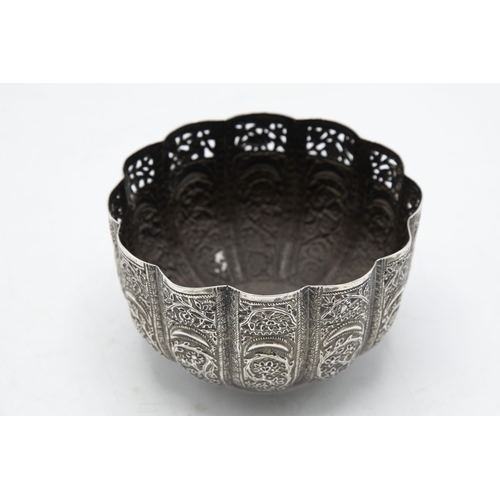 195 - Indian white metal (untested) lobed pedestal bowl embossed with scroll foliage, 11cm diameter, 6oz