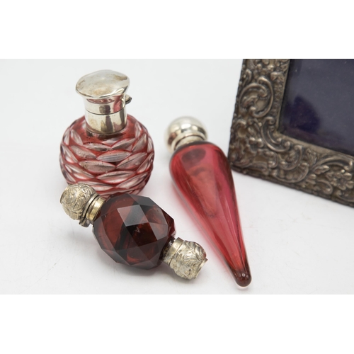 201 - Victorian silver mounted cranberry glass teardrop scent bottle, 13cm long, with a further silver and... 