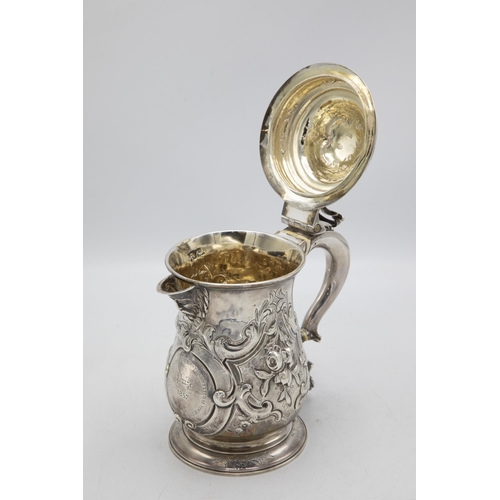 185 - Georgian silver lidded beer tankard jug, with later floral chasing and crest inscribed 'Prize 1857',... 