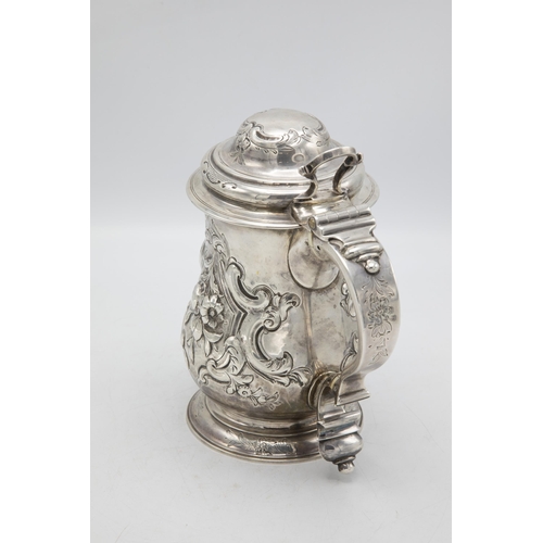 185 - Georgian silver lidded beer tankard jug, with later floral chasing and crest inscribed 'Prize 1857',... 