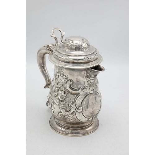 185 - Georgian silver lidded beer tankard jug, with later floral chasing and crest inscribed 'Prize 1857',... 