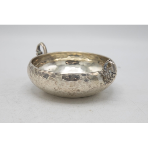 232 - Unusual Greek 925 silver quaich or wine taster, with hammered bowl and grapevine handles, 15.5cm wid... 