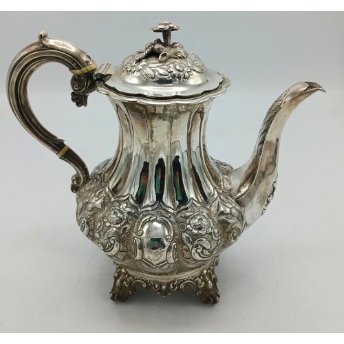 134 - Victorian silver lobed coffee pot chased with foliage, maker William Hewitt, London 1839, 25cm high,... 