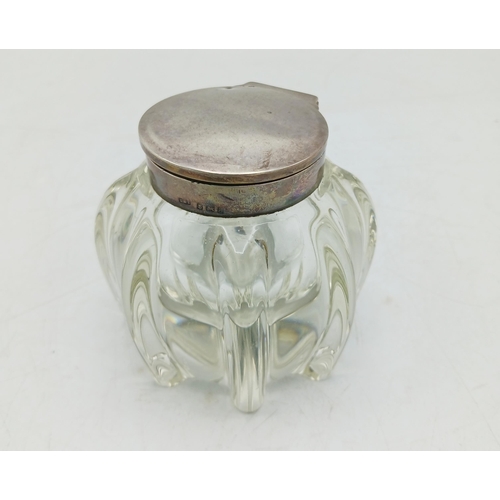 143 - Silver and glass desk and travel inkwells, the largest 8cm high (2)