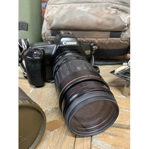 2305 - Quantity of photographic equipment to include Canon EOS camera, antique folding camera and Kowa TS-6... 