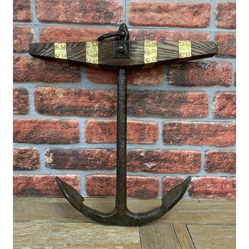 2216 - Cast iron maritime ships anchor with oak and brass panelled finish, H 55cm x W 47cm