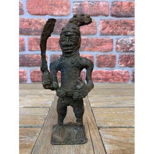 2099 - Tribal interest - Benin bronze figure of a standing tribesman holding a sword, 23cm high