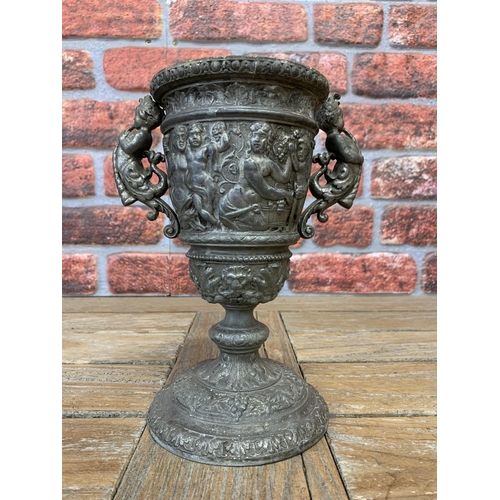 2225 - Pewter twin handled chalice, embossed with Bacchus bands and twin cornucopia mermaid handles, 23cm h... 