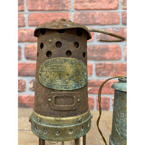 2227 - Two vintage brass and tin Welsh miners lamps by Thomas and Williams Ltd, 27cm and 20cm respectively ... 