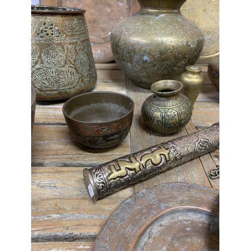 2229 - Mixed collection of Persian or Ottoman copper and brass ware to include jardinieres, pots, chargers ... 