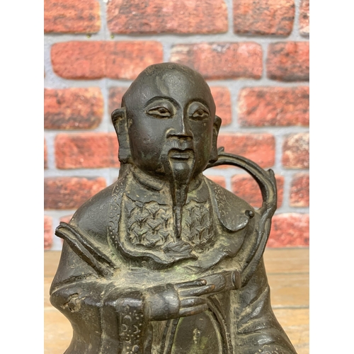 2101 - Early Chinese bronze (possibly 16th century) figure of a seated nobleman, with ebonised wooden plint... 