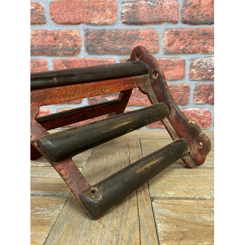 362 - Good quality 19th century cast iron and mahogany saddle rack, with red gesso painted finish, 47cm de... 