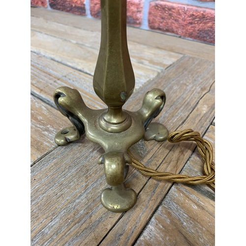 2372 - Antique brass Pullman lamp with faceted baluster column and typical scrolled feet, 30cm high