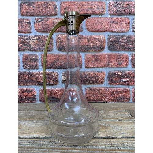 2235 - WMF secessionist art nouveau brass and glass claret jug, 31cm high