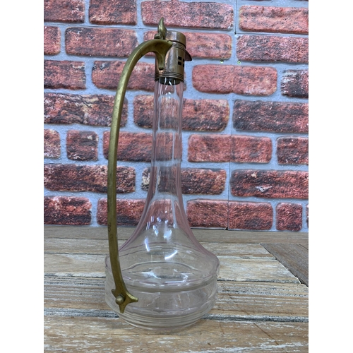 2235 - WMF secessionist art nouveau brass and glass claret jug, 31cm high