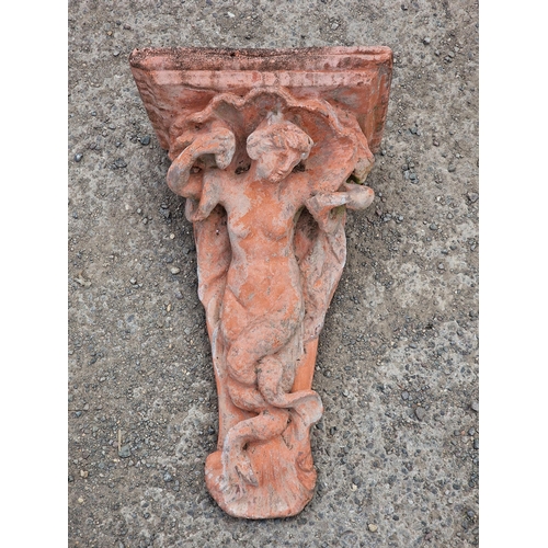 1005 - Well weathered composite terracotta Regency style wall bracket, in the form of a mermaid, 52 x 32cm