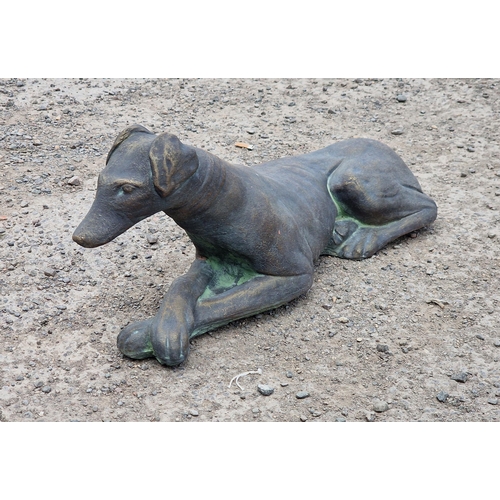 1009 - Composite terracotta recumbent greyhound with gilt finish, 60cm long