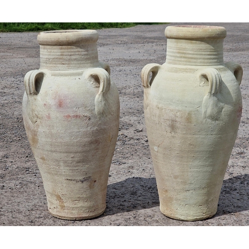 1014 - Pair of stained terracotta baluster amphoras each with four ring handles, 68cm high