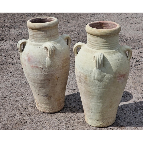 1014 - Pair of stained terracotta baluster amphoras each with four ring handles, 68cm high