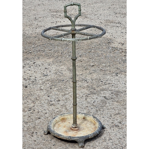 1313 - 19th century brass simulated bamboo four divisional stick stand, cast iron base, 65cm high