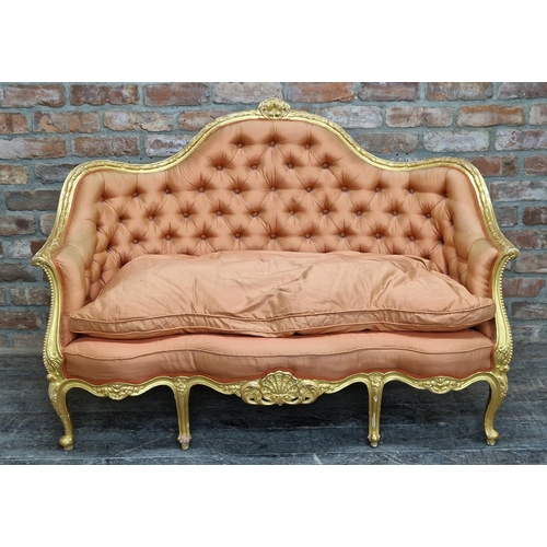 1338 - Antique French gilt wood sofa with coral button back upholstery and foliate decoration, raised on ca... 