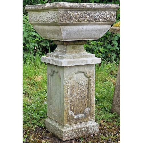 1045 - A three sectional weathered reconstituted stone garden urn with foliate decoration and fielded colum... 