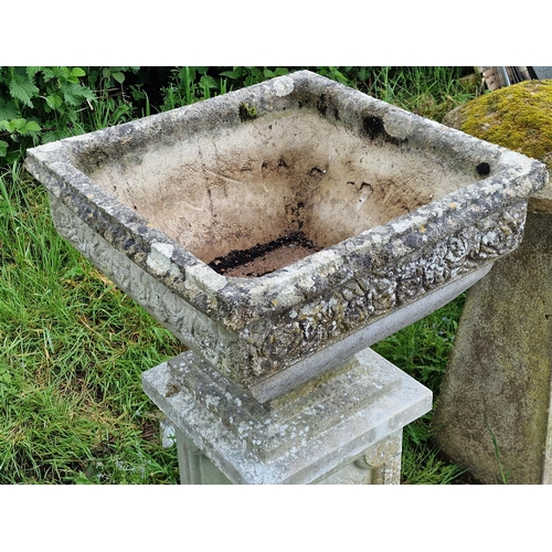 1045 - A three sectional weathered reconstituted stone garden urn with foliate decoration and fielded colum... 