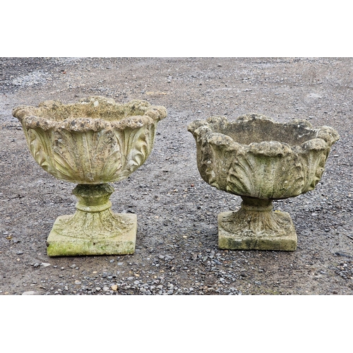 1055 - A matched pair of reconstituted stone garden urns of acanthus leaf design, H 45cm (largest) (2)