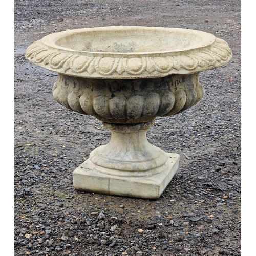 1056 - A reconstituted stone garden urn with lobed bowl and flared egg and dart rim, H 42cm x W 56cm