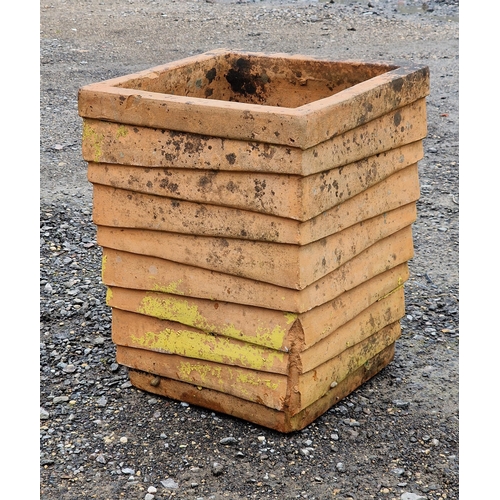 1059 - A weathered terracotta planter of louvred form, H 48cm x W 36cm x D 36cm