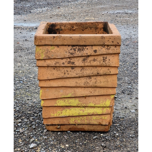 1059 - A weathered terracotta planter of louvred form, H 48cm x W 36cm x D 36cm