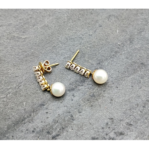 50 - Pair of gold diamond and pearl drop earrings, 25mm drop, 2.9g
