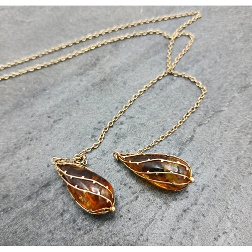 67 - Unusual 9ct chain each end terminating in large amber drops, 60cm long, 10.1g