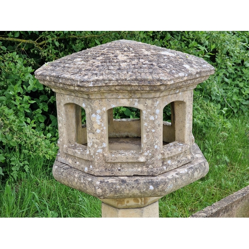 1044 - A three sectional weathered reconstituted stone garden bird table of octagonal form with simulated t... 