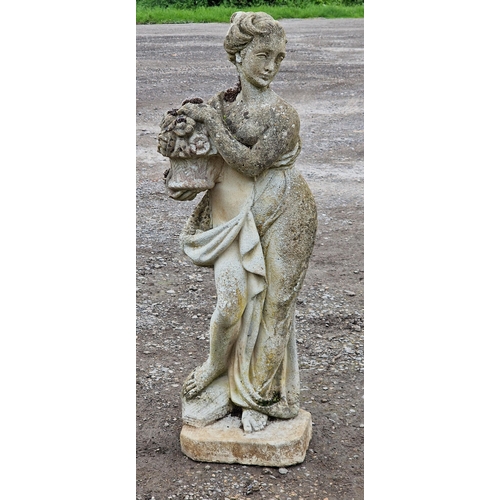 1046 - Weathered reconstituted stone garden statue of a robed maiden holding flowers, H 90cm x W 30cm