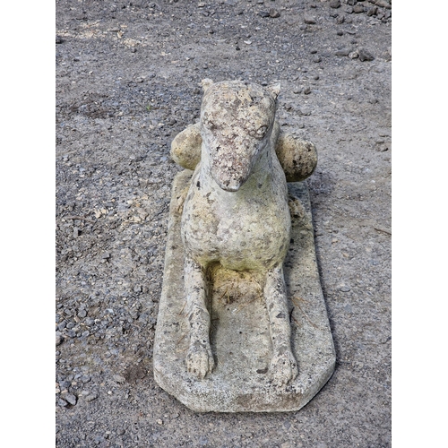 1074 - Reconstituted stone statue in the form of a recumbent greyhound, H 38cm x W 68cm x D 24cm