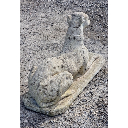 1074 - Reconstituted stone statue in the form of a recumbent greyhound, H 38cm x W 68cm x D 24cm