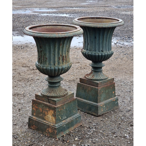 1080 - A good quality pair of painted cast iron Campana urns with egg and dart rims and lobed bowls raised ... 