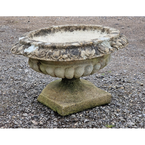 1082 - A reconstituted stone garden urn with lobed bowl and flared egg and dart rim, H 38cm