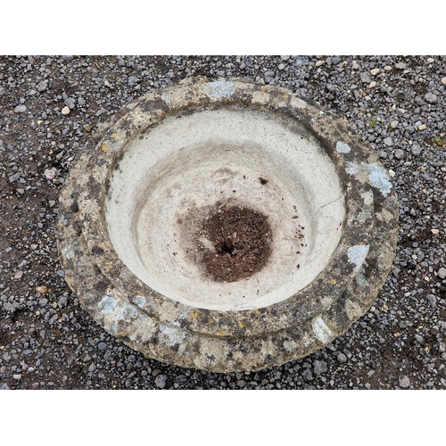 1082 - A reconstituted stone garden urn with lobed bowl and flared egg and dart rim, H 38cm