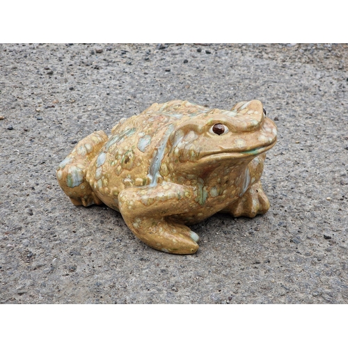 1084 - A ceramic garden ornament in the form of a toad, signed Jean Fowler, H 8cm x W 25cm